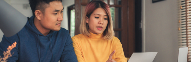 Couple reviewing tax documents and discussing filing bankruptcy